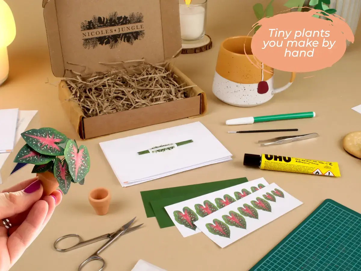 Miniature paper houseplants styled on a calm crafting surface