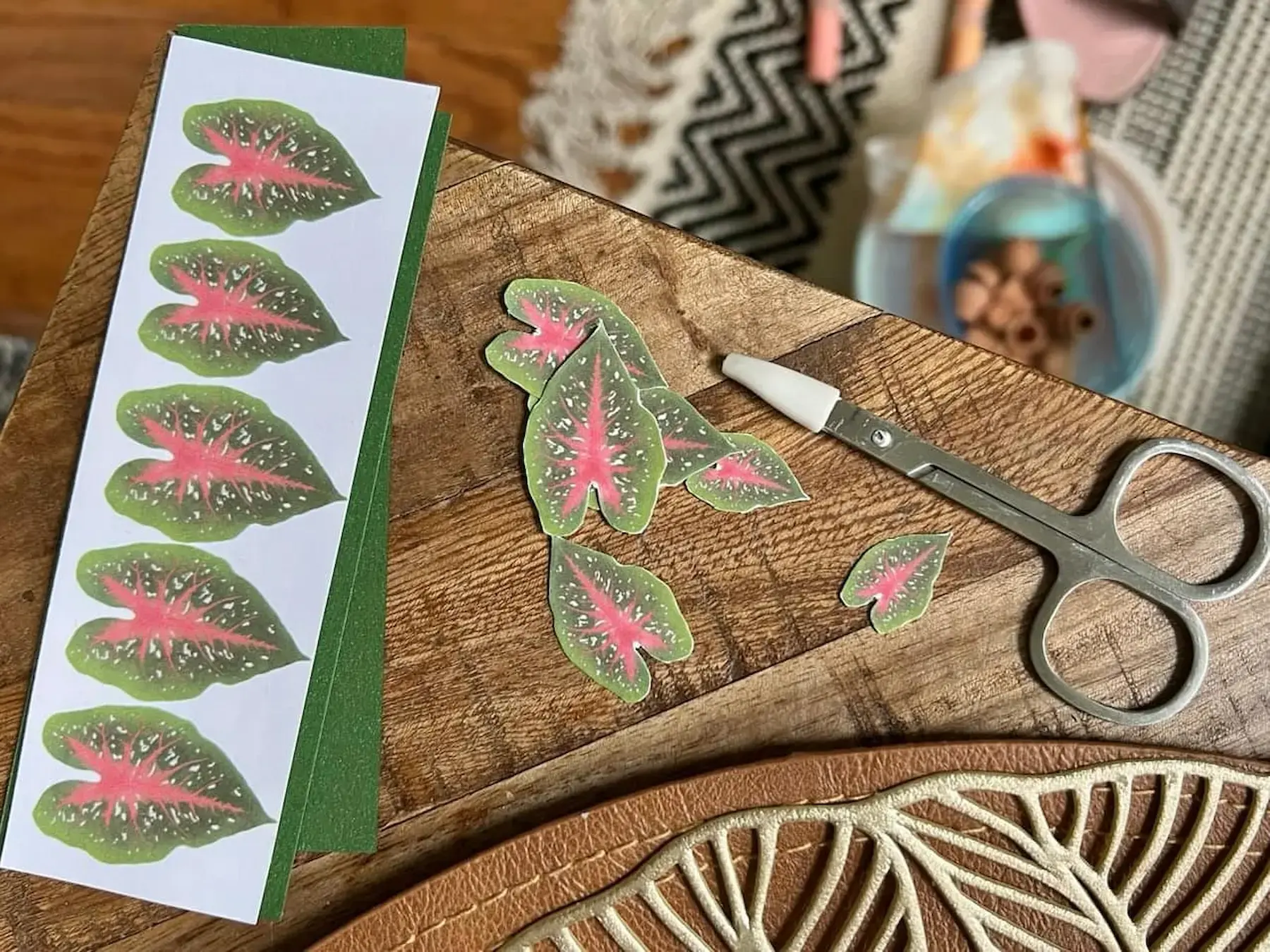 Customer crafting a paper Caladium Red Flash on a wooden table