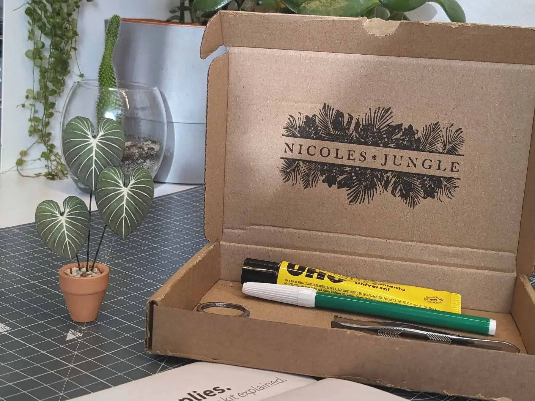Customer crafting a paper Philodendron gloriosum at a desk